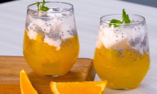 Dua gelas es kelapa muda dengan jelly jeruk diletakkan di atas talenan untuk takjil buka puasa.